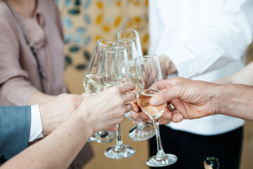 Cheers. Hands clink glasses of champagne, sparkling wine. Wedding ceremony celebration. Close up
