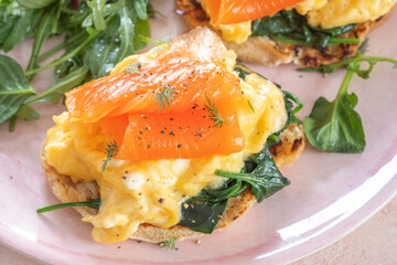 Scrambled eggs with smoked salmon and avocado on a whole wheat toast