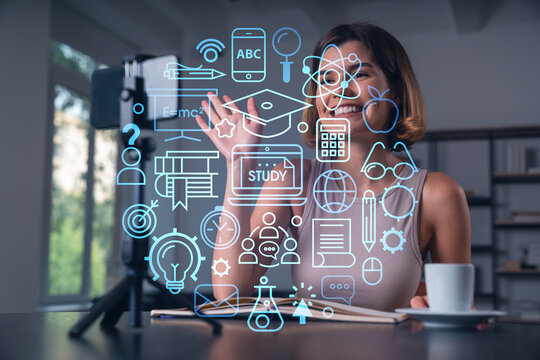 Happy woman is making video blog using smartphone on a tripod explaining with hands at office workplace. Concept of online stream, business education, conference call. Education hologram - Powered by Adobe