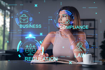 Smiling woman in casual wear taking notes in notebook at office workplace with coffee cup. Concept...