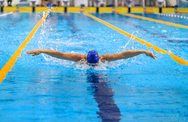 butterfly stroke man swimmer swimming in pool