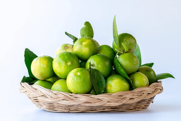Fresh green oranges in basket , Fresh green oranges at market and shop for sell..Fresh green lemons, in basket , Fresh green lemons at market and shop for sell.