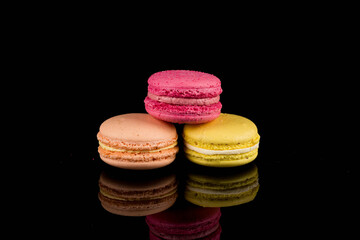 Colorful macaroon over black background