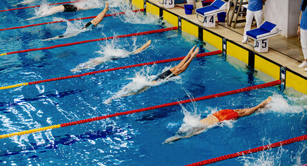 starting athletes swimmers backstroke swim in swimming competition