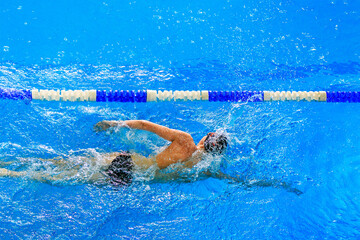 men athlete swimmer freestyle swim in swimming competition