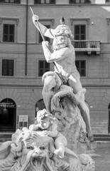 Statue of Neptune in Piazza Navona in Rome, front view, black and white photo.
