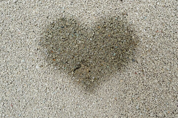 Animal urine in heart shape images on sand surface. Pets care and hygiene concept.
