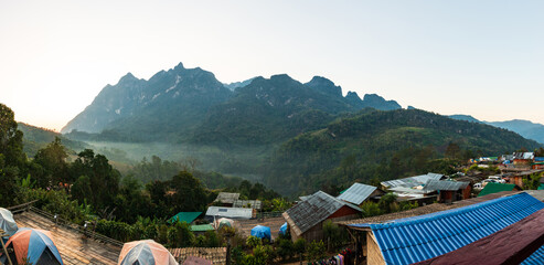 Panoramic view of Doi Luang Chiang Dao, (Doi Chiang Dao) is the third highest peak mountain in Thailand while morning mist flows through the valley area, Chiang Dao District, Chiang Mai, Thailand.