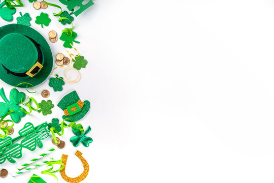 St Patrick flatlay background with shamrock clover leaves, leprechaun hat decor, golden coin, party accessories, symbols of Patrick day
