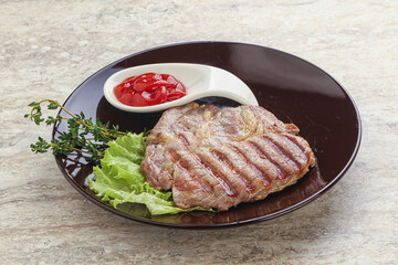 Grilled pork neck steak with ketchup