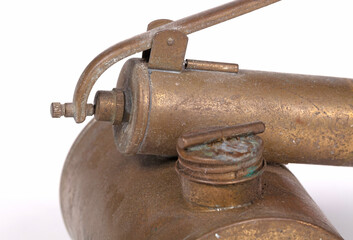 Old brass insecticide spray on white background