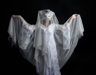 close up portrait of beautiful woman wearing  white bridal fantasy  gown with butterfly mask and...