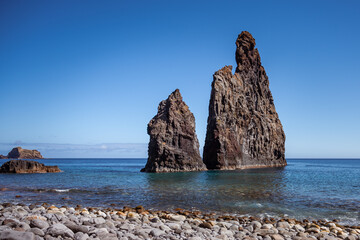 Fototapeta na wymiar Lava islets in Ribeira da Janela at stony beach - Wild and beautiful coast with rock formations in the ocean near Porto Moniz on the island Madeira, Portugal