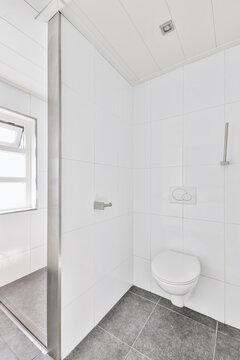 Interior of small restroom with wall mounted toilet