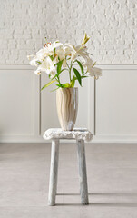 Vase of plant and flower style on the chair, white wall background.