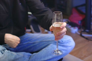 a person holding a glass with champagne