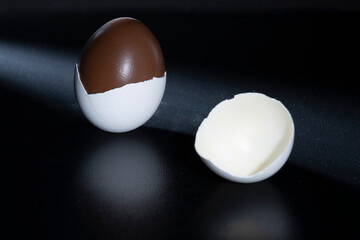 Traditional Finnish cuisine: Traditional nougat and chocolate-filled egg shell against a dark background