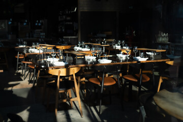 Indoor restaurant setup with a dish and glasses on the wooden table