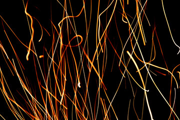 Striking fire sparks captured through long exposure for a dynamic and abstract effect. Ideal for advertisements, digital and print media.