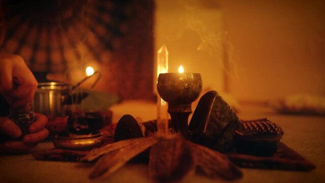 Cacao ceremony space, heart opening medicine. Burning incense at the altar with a labradorite and woman who takes care of the fumigation with incense.