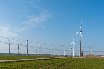 Wind farm with wind turbines and power lines in Lichtenau