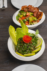 Fattouch and tabouleh Lebanese salad isolated on white, traditional lebanese salad of tabbouleh and fattouch