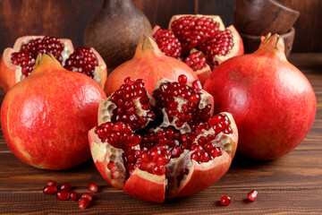 Close-up view of fresh pomegranate slices on wooden background. Selective focus.