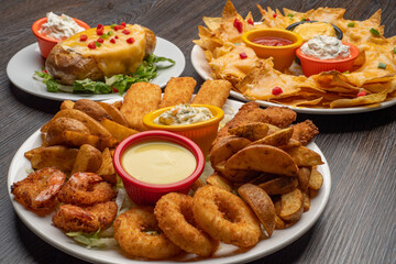 Combo plate of Cheese balls, Mozzarella cheese, Wedges, Garlic Bread, Chicken Tenders with sauce