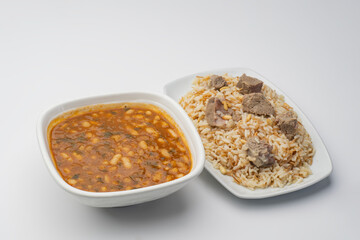 Baked Beans in tomato sauce served with rice, pine nuts, and meat  - Arabian food of Beans, rice, and meat 