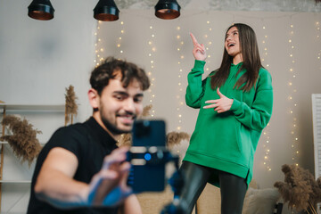 Video bloggers, male and female live streaming with smart phone creating and sharing content for social networks.