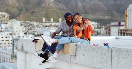 Selfie, rooftop and couple with skateboard and smartphone for social media post, social network update or gen z lifestyle blog with urban cityscape. Influencer black people friends in phone portrait - Powered by Adobe