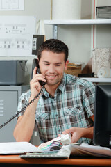 man smiling while on the telephone