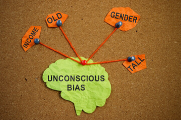 Paper brain pinned pined to the board. Unconscious bias concept. - obrazy, fototapety, plakaty
