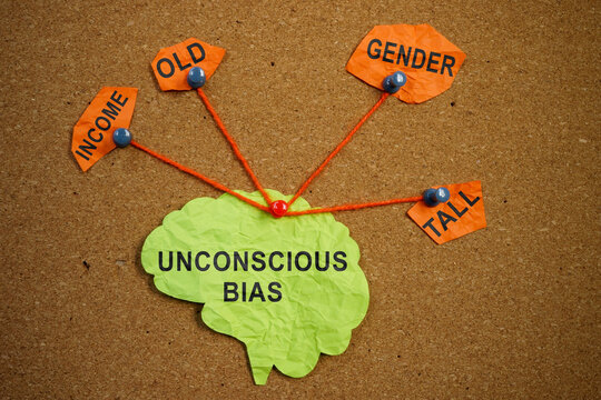 Paper brain pinned pined to the board. Unconscious bias concept.