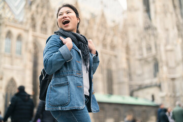 carefree Asian woman enjoy sight seeing travel in front of famous church in Vienna tour in downtown. Young woman exploring famous old architecture Stephansdom cathedral church in downtown