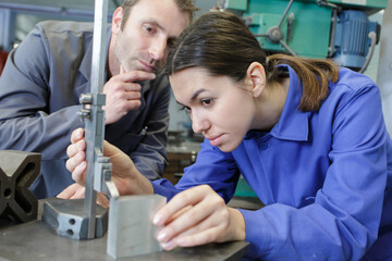 engineer showing equipment to a female apprentice