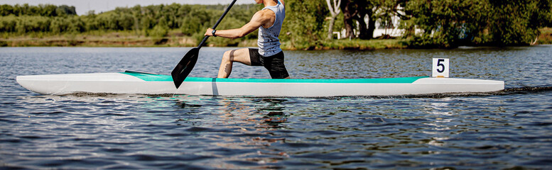 man athlete canoeist rowing in canoe competition race