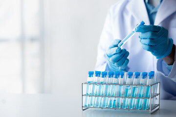 Lab practitioner working on chemical research for chemical reactions, does a chemical experiment and examines a patient's blood sample. Medicine and research concept.