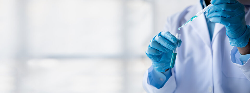 Lab practitioner working on chemical research for chemical reactions, does a chemical experiment and examines a patient's blood sample. Medicine and research concept.