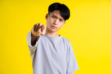 image of handsome young man posing on a yellow background