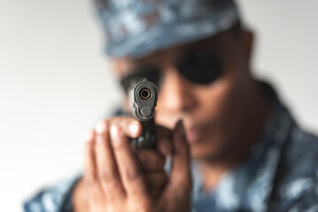 Police cop constable holding Pistol Is preparing to shoot bandit culprit in abandon building. Cop hunter killer use black glasses preparing with short handgun.