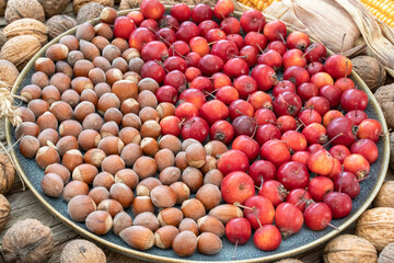 Ein Teller mit Haselnüssen und Zieräpfel aus dem eigenen Garten. 