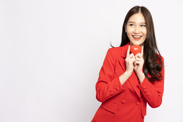 Young Asian businesswoman holding red heart isolated on white background