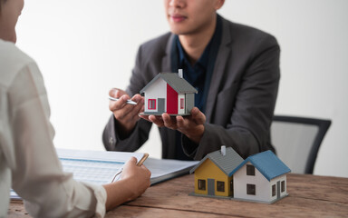 Sealing a deal. Asian people business real estate agent with client consulting and discussing at...