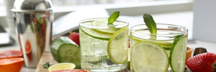 Preparation of chilled lime with cucumber punch homemade cocktail closeup