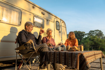 Obraz na płótnie Canvas Happy family eating breakfast at tent camping.