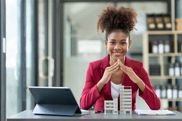 African american female architect or designer, businessman, and engineer working in the office on building projects Residential condos to buy and rent real estate projects.