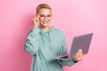 Photo portrait of pretty young girl spectacles netbook apple macbook samsung wear trendy khaki look isolated on pink color background