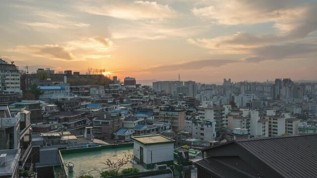 Seoul South Korea time lapse 4K, city skyline night to day sunrise timelapse at Seoul city center view from Naksan Park in autumn