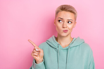 Photo of young funny girl wearing trendy khaki hoodie pouted lips uncertain look sale direct finger...